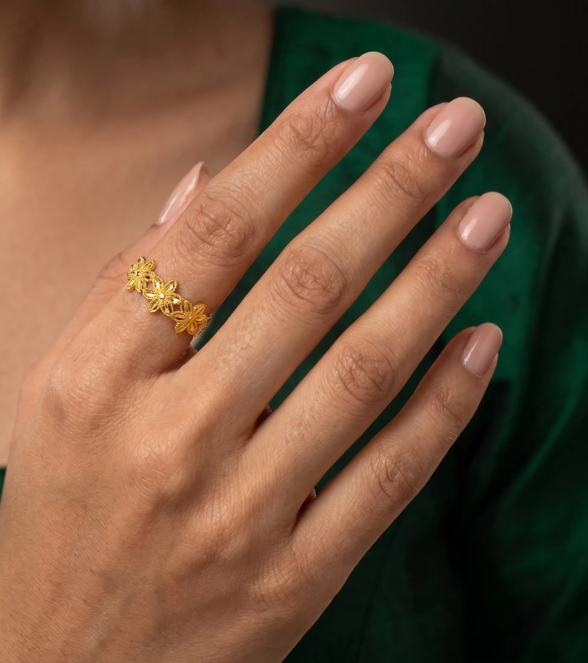 Intricate gold ring on finger